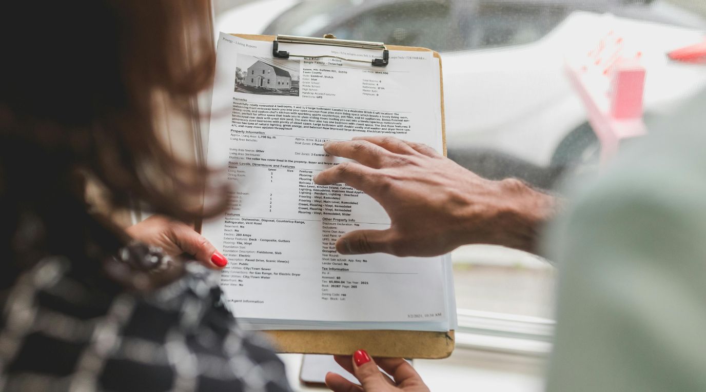 A real estate agent discussing property information during a consultation.